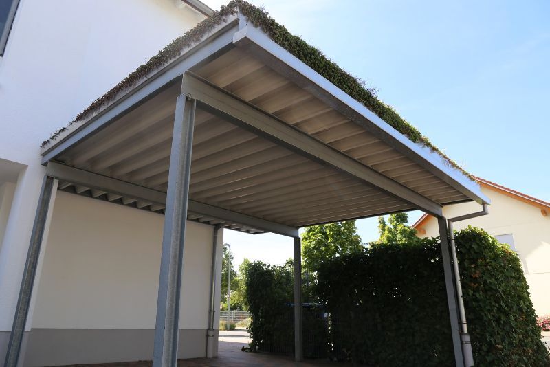 open carport with turf on the roof attached to the house